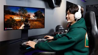 LG 27-inch 480Hz Gaming OLED on a desk with a gamer sat in front of the screen