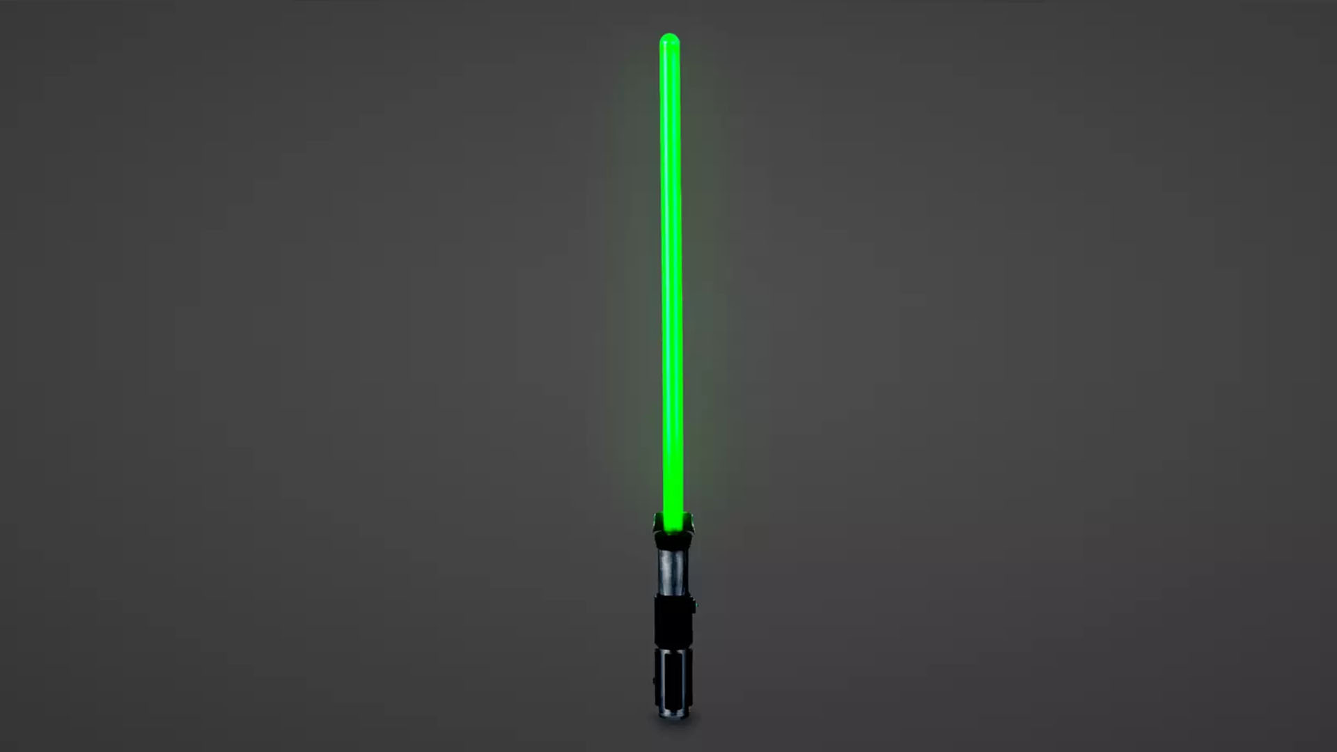 A Star Wars Yoda Lightsaber toy against a grey background.