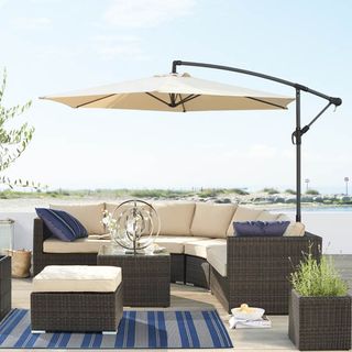 garden area with parasol and coffee table with footstool