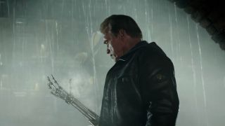 Arnold Schwarzenegger looking at his robotic arm in Terminator Genisys.