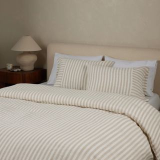 Neutral bedroom with beige and white striped bedding 