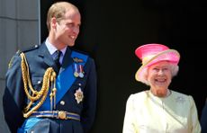 Prince William, Duke of Cambridge and Queen Elizabeth II watch a flypast of Spitfire & Hurricane aircraft from the balcony of Buckingham Palace