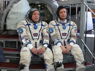 Expedition 51 crewmembers Fyodor Yurchikhin of Roscosmos (left) and Jack Fischer of NASA (right) answer questions from the press at the Gagarin Cosmonaut Training Facility in Star City, Russia. The March 31, 2017 interview took place at a Soyuz spacecraft mockup on day two of the final qualification exams for the astronauts.