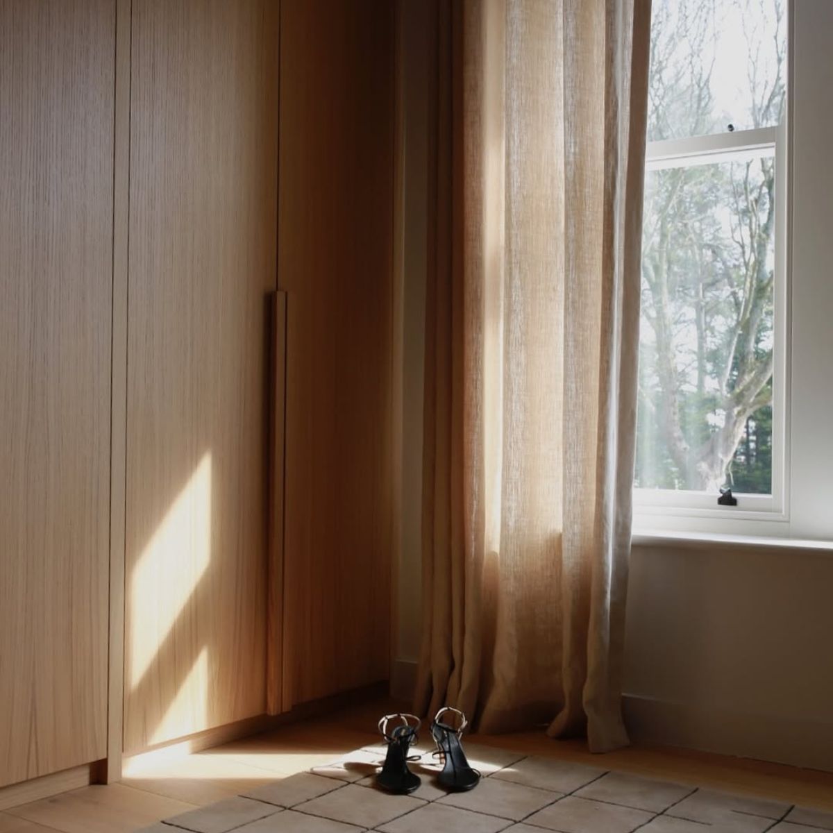 Wood closet with curtains and shoes in front