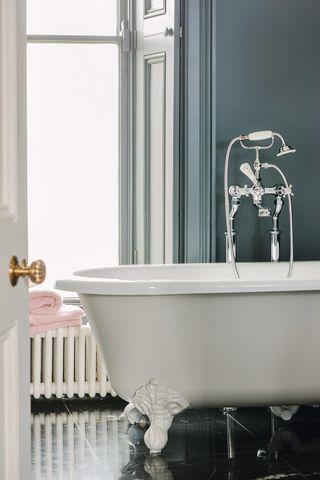 Roll top claw foot bath in classic style bathroom