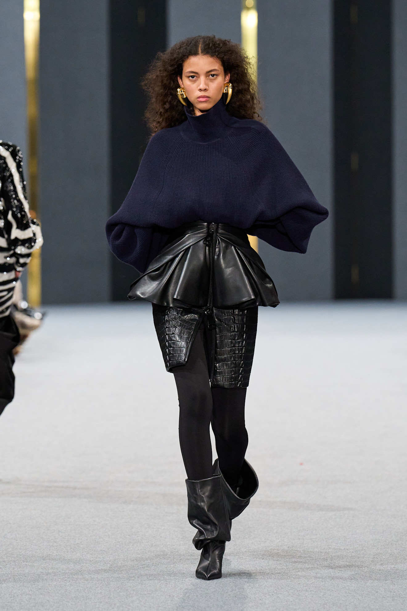 A model wears slouchy boots on Balmain&#039;s autumn/winter 2025 runway