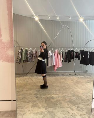 Sandy Liang taking a mirror selfie in her store on Orchard Street