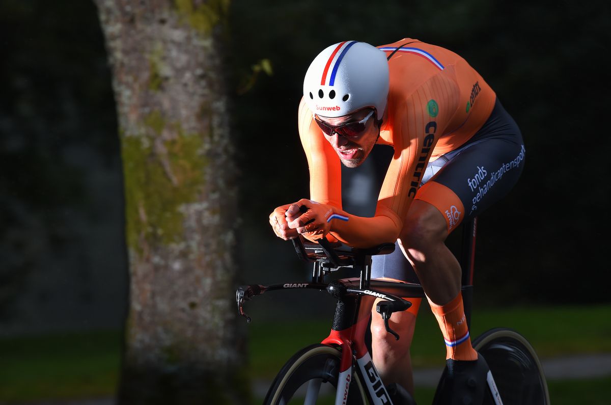 Tom Dumoulin riding out of the shadows and into the rainbow jersey