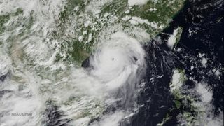 Typhoon Rammasun's eye was over the northern part of China's Hainan Island when this image was taken by the JMA MTSAT-2R satellite on July 18, 2014. The typhoon underwent rapid intensification before making landfall.