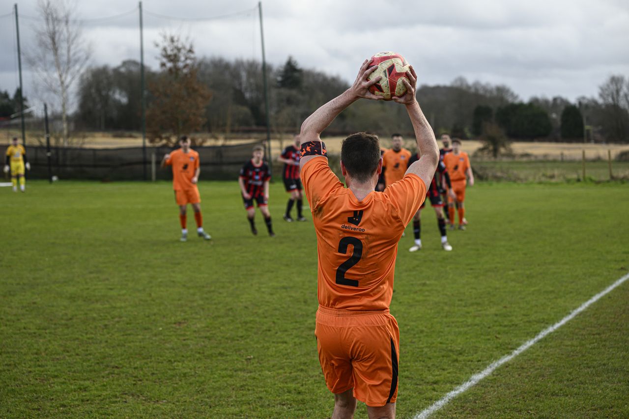 Two footballers playing a match