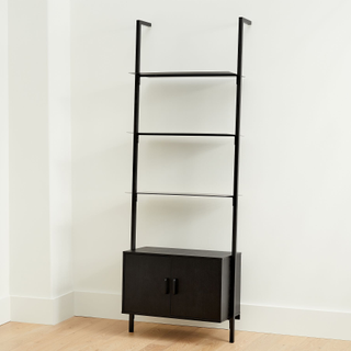 black ladder bookshelf with cabinet at the bottom