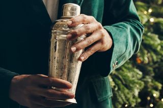 Person using a cocktail shaker