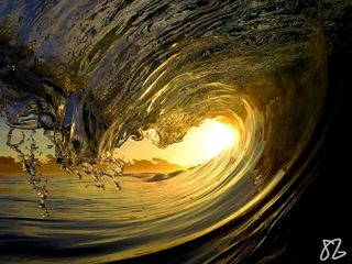 a yellow sunset and a wave near Monterey, California