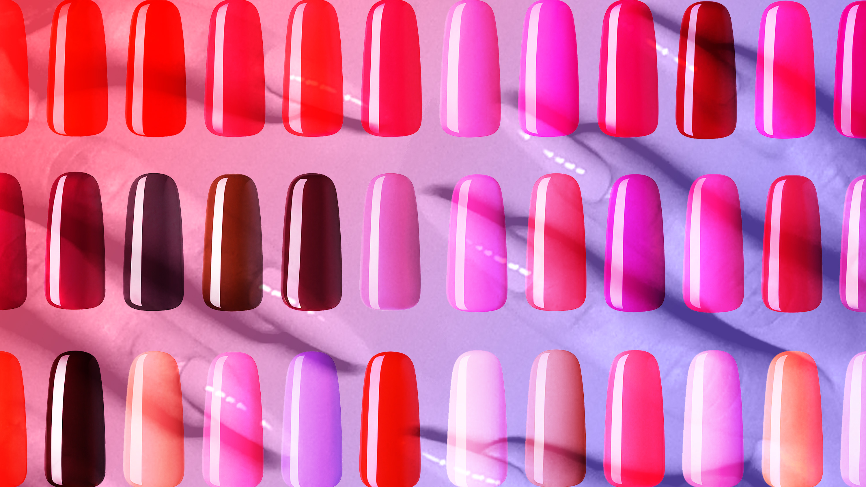 three rows of press on nails in red, pink, and burgundy on a purple and pink background