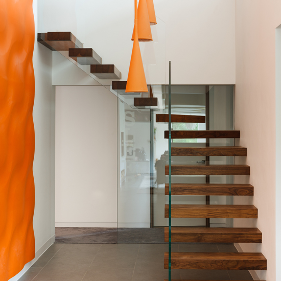 floating staircase with wooden staircase and grey flooring