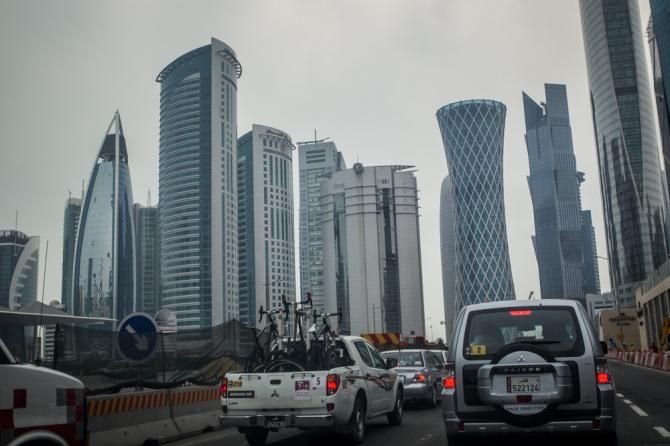 The race caravan rolls through downtown Doha.