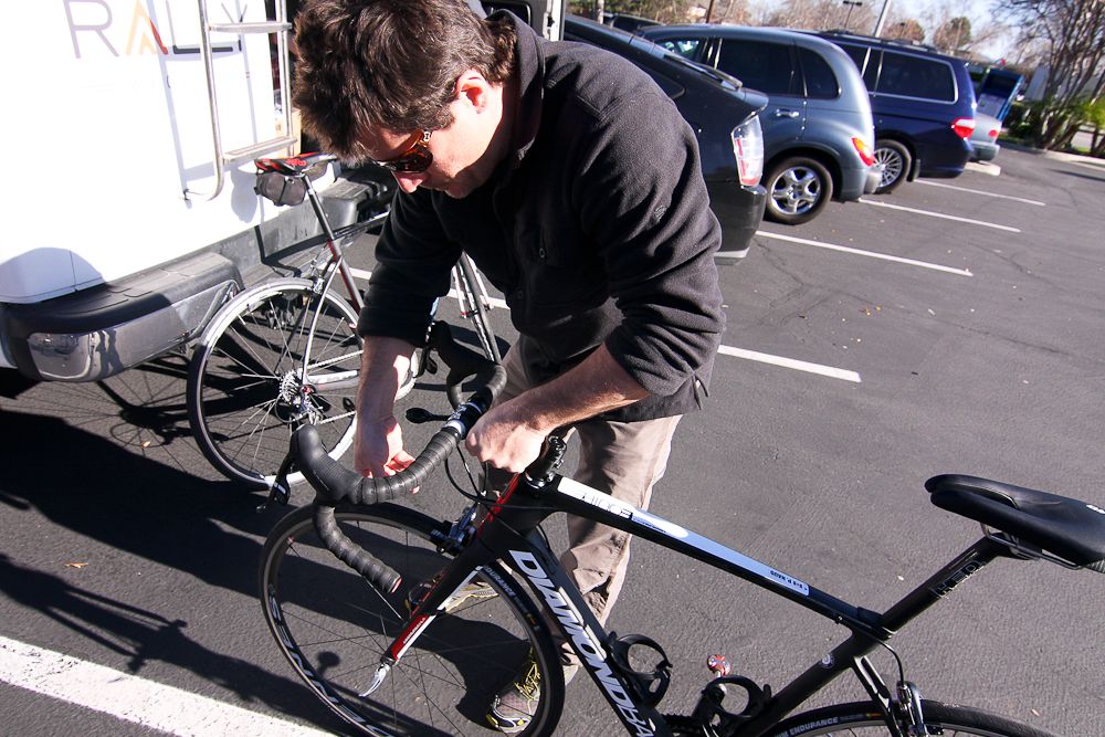 Director Jonas Carney gets one of the team bikes ready for a training ride.