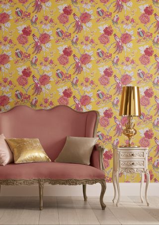 bright yellow and pink floral wallpaper with pink sofa