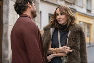 an actor and an actress look at each other in a scene from Emily in Paris