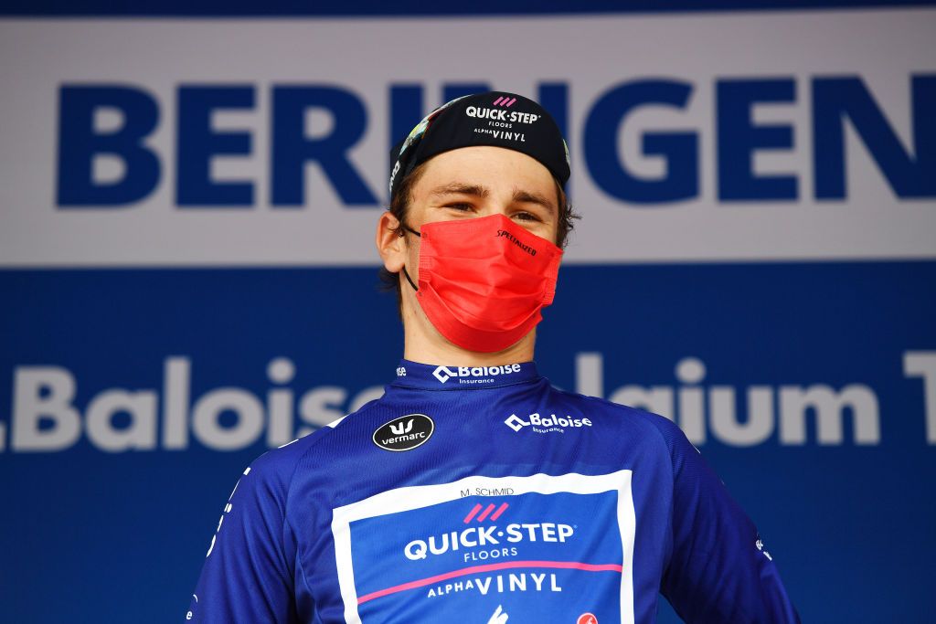 BERINGEN BELGIUM JUNE 19 Mauro Schmid of Switzerland and Team QuickStep Alpha Vinyl celebrates winning the blue leader jersey on the podium ceremony after the 91st Baloise Belgium Tour 2022 Stage 5 a 1799km stage from Gingelom to Beringen BaloiseBelgiumTour on June 19 2022 in Beringen Belgium Photo by Luc ClaessenGetty Images