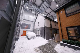 A fake snow-covered newbuild home inside the black box energy house project
