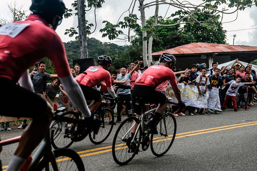 Amateur cyclist ride during the Giro de Rigo as fan cheers in San Carlos