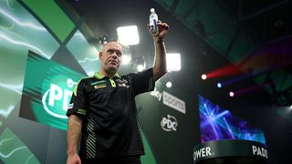 Michael van Gerwen raises his bottle of water to acknowledge the crowd during the 2026 PDC World Darts Championship