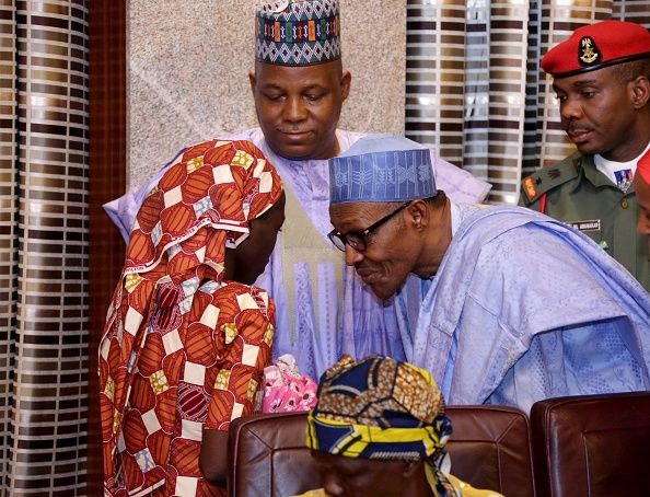 Nigerian President Mohammadu Buhari speaks with kidnapped Chibok schoolgirl Amina Ali.