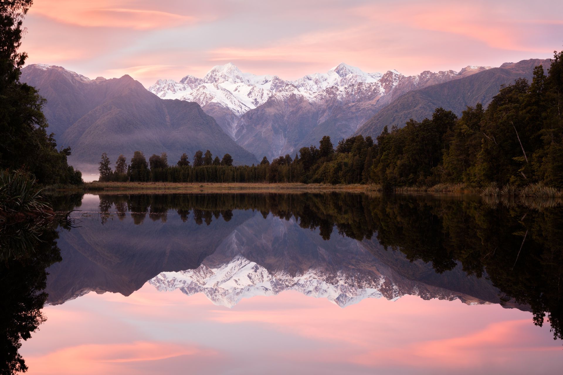 Pink sunrise over Lake Matheson, South Island, New Zealand