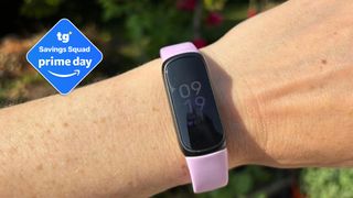 The image shows a close-up of woman's wrist, wearing a lilac watch with a slimline touch-screen watch face. Inset to the left, a deal badge reads: 'Tom's Guide Saving Squad Prime Day'