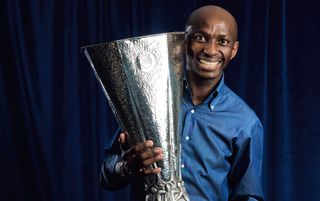Special guest Stephane Mbia poses with the UEFA Europa League trophy ahead of the UEFA Champions League 2023/24 Group Stage Draw at Le Méridien Hotel on August 31, 2023 in Monaco, Monaco.