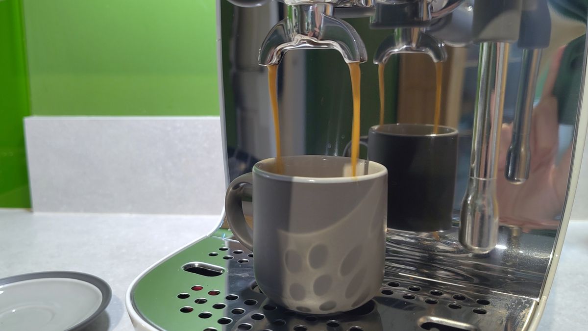 Smeg ECF03 espresso machine dispensing coffee into espresso cup
