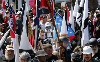 White nationalist demonstrators walk into Lee Park in Charlottesville, Virginia.