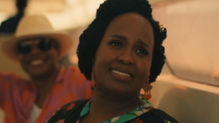 Natasha Rothwell's Belinda looking back at Pornchai as she sails home with her son in The White Lotus finale