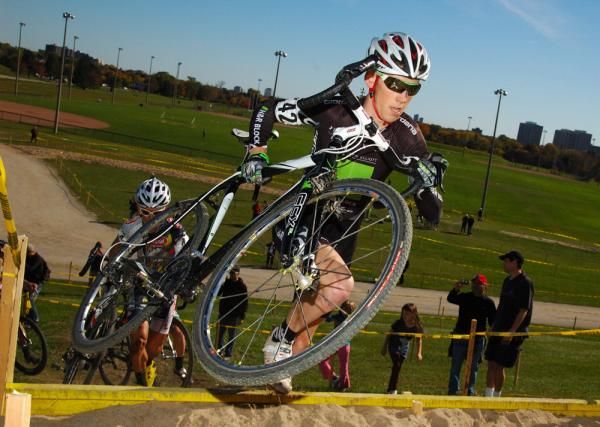 Aaron Schooler over the barrier ahead of Frattini on 1st lap.