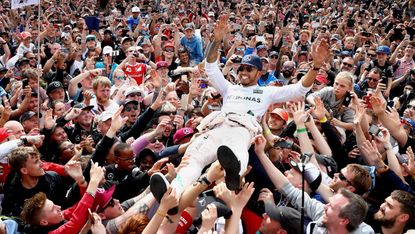 Lewis Hamilton celebrates with fans after winning the 2016 British Grand Prix at Silverstone