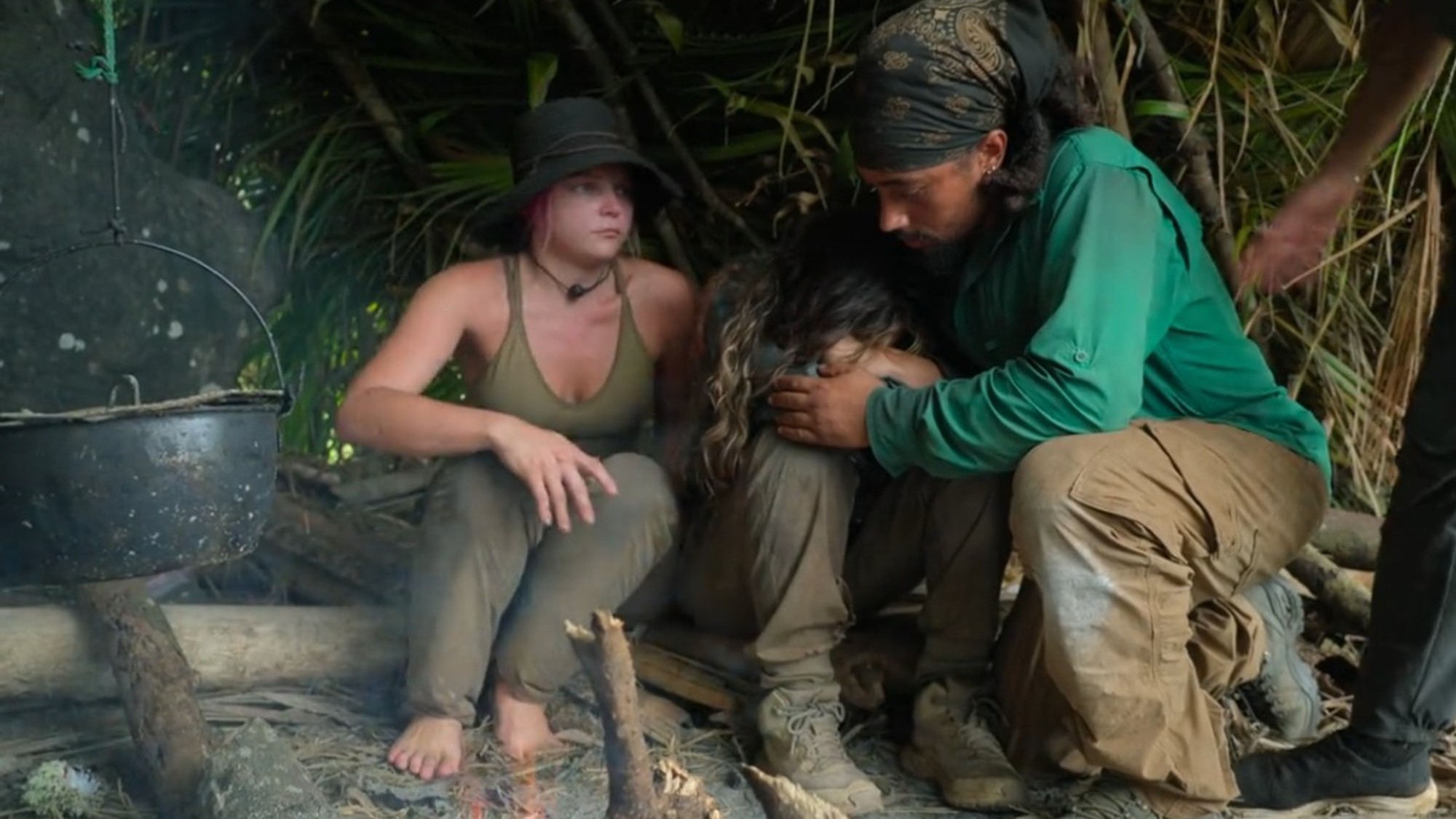 Sarah Awad being hugged by Pharaoh Gayles and Morgan Colburn on Outlast: The Jungle.