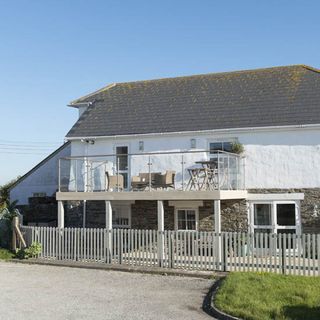 house exterior with fencing and stone walls