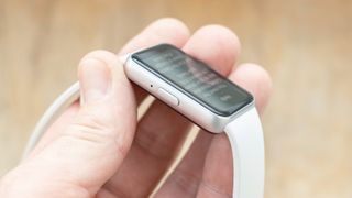 Close-up of the Samsung Galaxy Fit3 fitness tracker on a white rubber strap