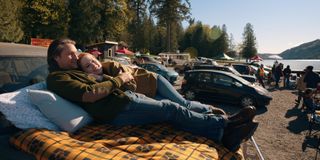 Alexandra Breckenridge as Mel Monroe and Martin Henderson as Jack Sheridan as they lay on a blanket in the back of a truck looking at the river in virgin river season 6