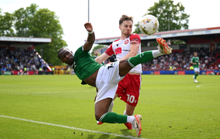 Tayo Edun of Stockport County is challenged by Dan Kemp of Stevenage during the Sky Bet League One Play-Off Semi-Final First Leg match between Stevenage and Stockport County at Stevenage FC Stadium