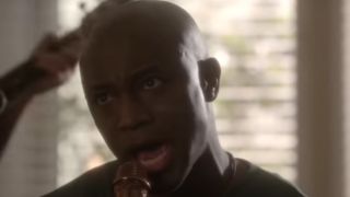 Close up of Taye Diggs with his mouth open, singing in NCIS