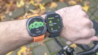 Samsung Galaxy Watch Ultra next to Apple Watch Ultra 2 on a user's wrist