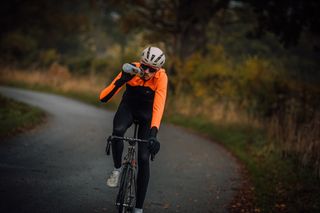 Male cyclist taking a sip from his water bottle during a bike ride