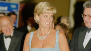 Princess Diana in a baby blue square neck dress with a diamond necklance on