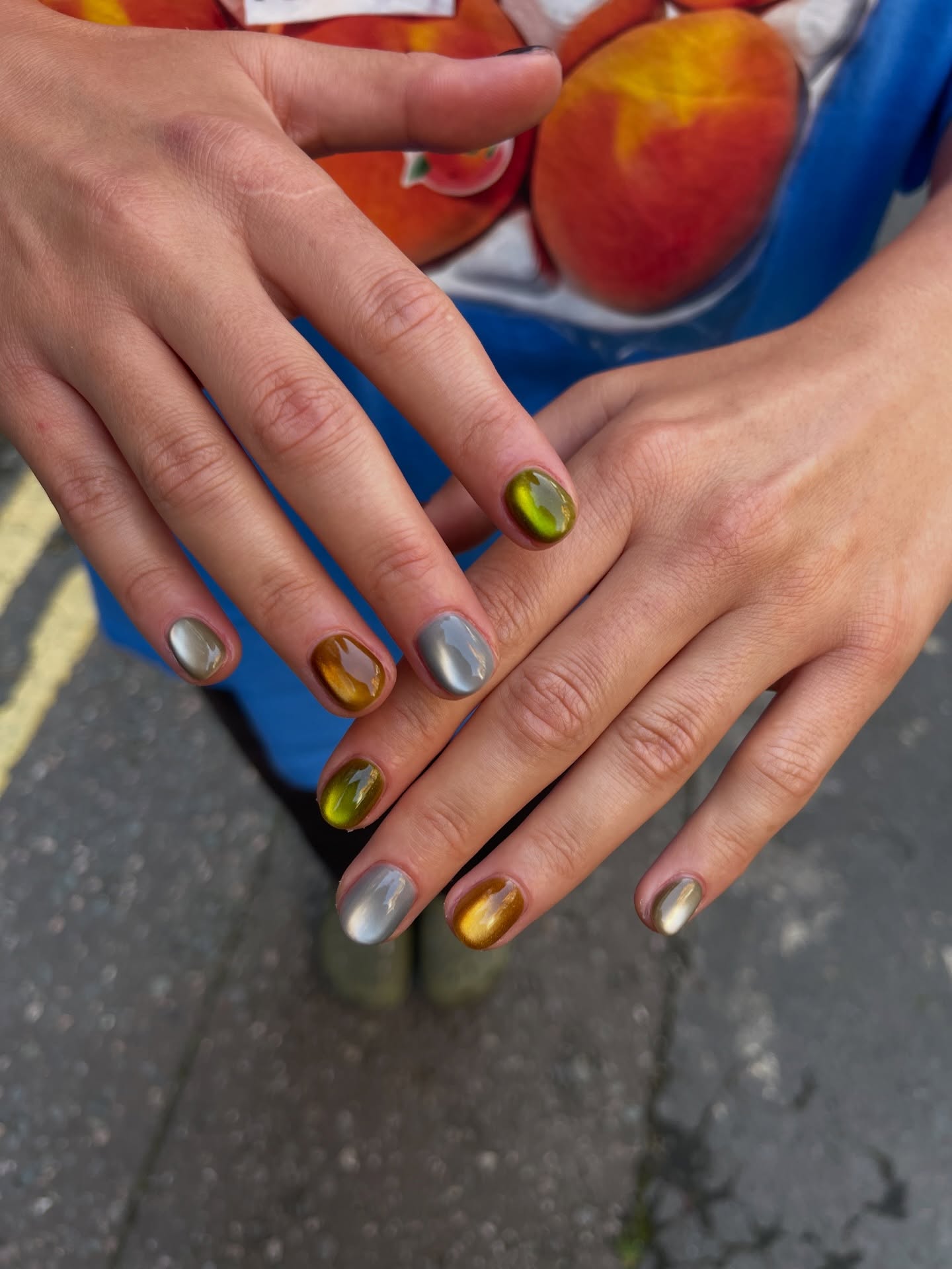 shiny cat eye nails with the colors of a fall landscape