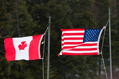 Canadian and American flags near the border in New Hampshire.