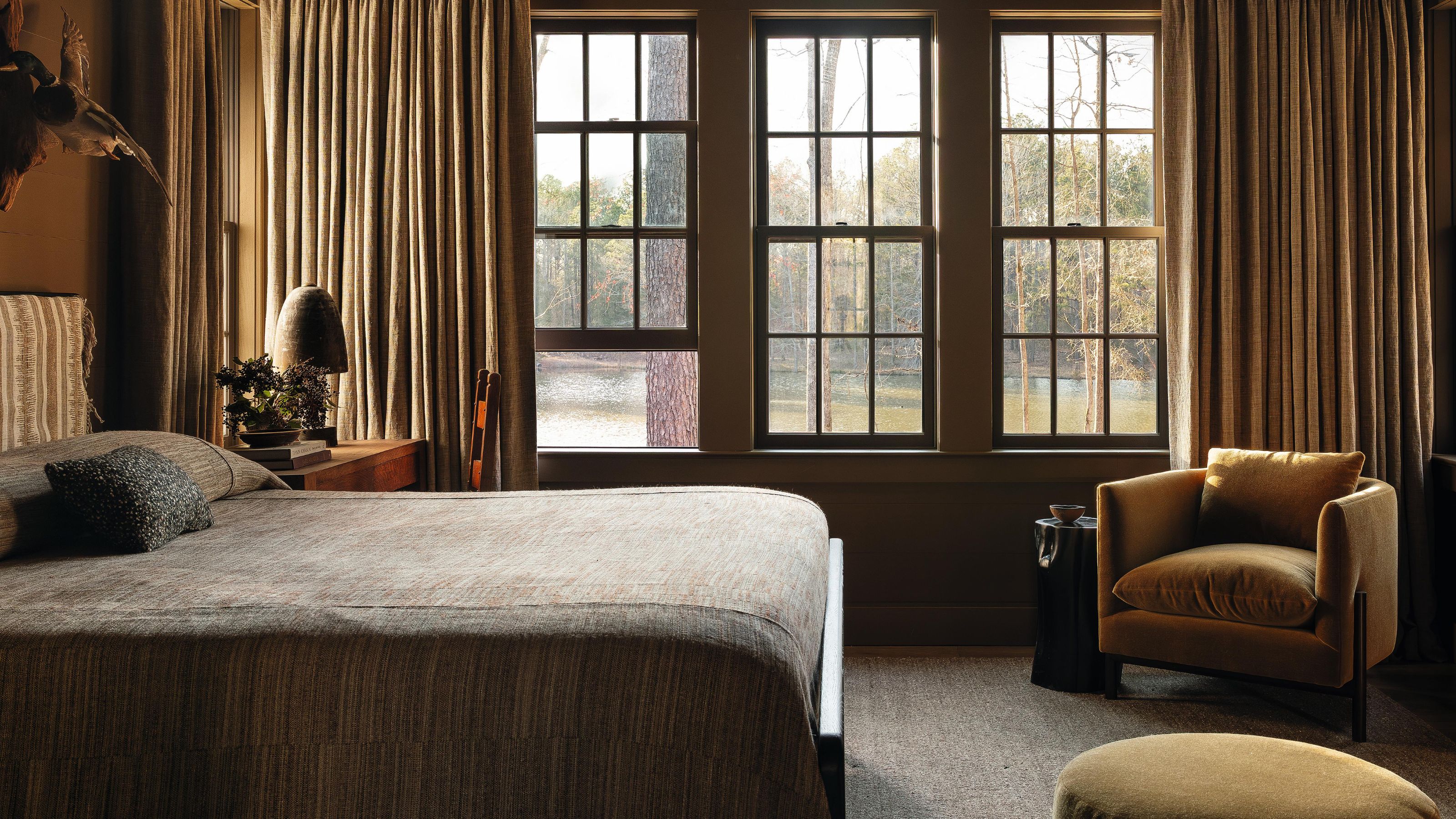 a warm neutral golden bedroom in a moody farmhouse home