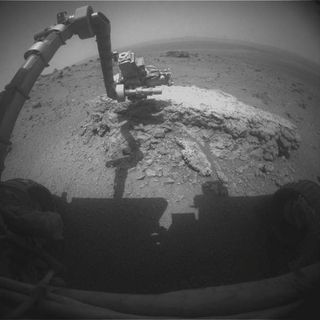 NASA's Mars rover Opportunity used its front hazard-avoidance camera to take this picture showing the rover's arm extended toward a light-toned rock, "Tisdale 2," during the 2,695th Martian day, or sol, of the rover's work on Mars (Aug. 23, 2011). Tisdale 2 is about 12 inches (30 cm) tall.