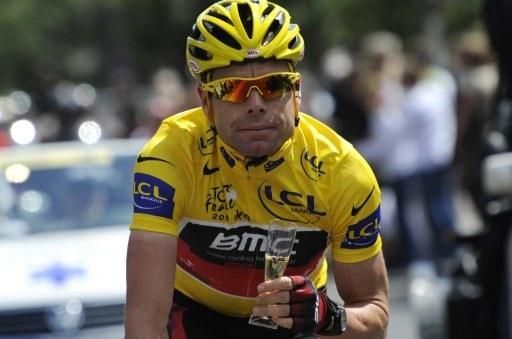 Cadel Evans (BMC) toasts Tour de France victory on the road to Paris.